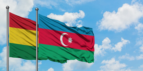 Bolivia and Azerbaijan flag waving in the wind against white cloudy blue sky together. Diplomacy concept, international relations.