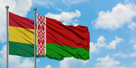Bolivia and Belarus flag waving in the wind against white cloudy blue sky together. Diplomacy concept, international relations.