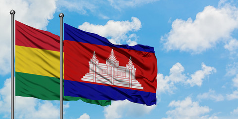 Bolivia and Cambodia flag waving in the wind against white cloudy blue sky together. Diplomacy concept, international relations.