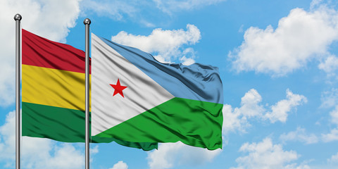 Bolivia and Djibouti flag waving in the wind against white cloudy blue sky together. Diplomacy concept, international relations.