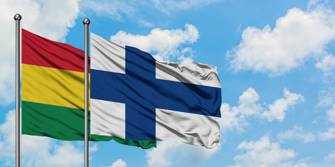Bolivia and Finland flag waving in the wind against white cloudy blue sky together. Diplomacy concept, international relations.