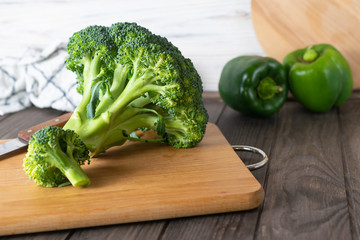 Fresh organic green broccoli ingredient on wooden board in the kitchen