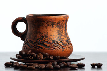 Cup of coffee. Coffee beans. White background dark bottom.