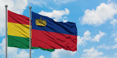 Bolivia and Liechtenstein flag waving in the wind against white cloudy blue sky together. Diplomacy concept, international relations.