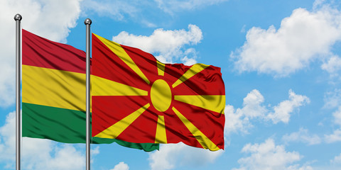 Bolivia and Macedonia flag waving in the wind against white cloudy blue sky together. Diplomacy concept, international relations.