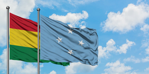 Bolivia and Micronesia flag waving in the wind against white cloudy blue sky together. Diplomacy concept, international relations.