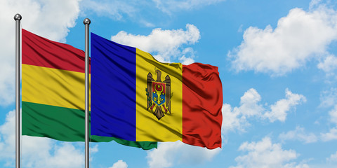 Bolivia and Moldova flag waving in the wind against white cloudy blue sky together. Diplomacy concept, international relations.