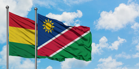 Bolivia and Namibia flag waving in the wind against white cloudy blue sky together. Diplomacy concept, international relations.