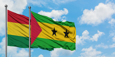 Bolivia and Sao Tome And Principe flag waving in the wind against white cloudy blue sky together. Diplomacy concept, international relations.