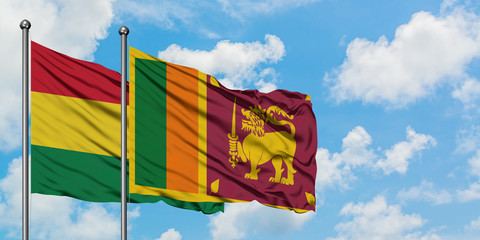 Bolivia and Sri Lanka flag waving in the wind against white cloudy blue sky together. Diplomacy concept, international relations.