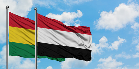 Bolivia and Yemen flag waving in the wind against white cloudy blue sky together. Diplomacy concept, international relations.