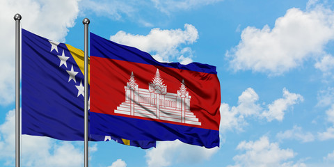 Bosnia Herzegovina and Cambodia flag waving in the wind against white cloudy blue sky together. Diplomacy concept, international relations.