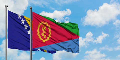 Bosnia Herzegovina and Eritrea flag waving in the wind against white cloudy blue sky together. Diplomacy concept, international relations.
