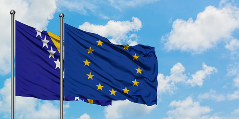 Bosnia Herzegovina and European Union flag waving in the wind against white cloudy blue sky together. Diplomacy concept, international relations.