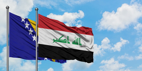 Bosnia Herzegovina and Iraq flag waving in the wind against white cloudy blue sky together. Diplomacy concept, international relations.