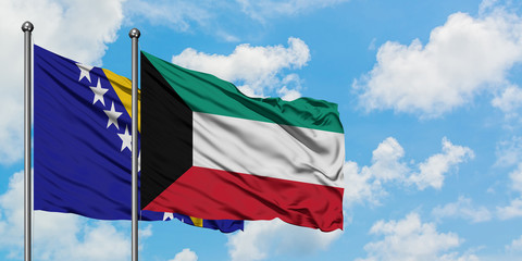Bosnia Herzegovina and Kuwait flag waving in the wind against white cloudy blue sky together. Diplomacy concept, international relations.