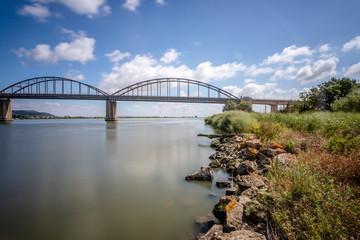 Long exposure landscape image of bridge Marechal Carmona on river Tejo in Vila Franca Xira, Portugal.