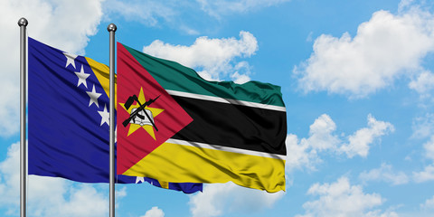 Bosnia Herzegovina and Mozambique flag waving in the wind against white cloudy blue sky together. Diplomacy concept, international relations.