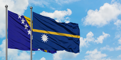 Bosnia Herzegovina and Nauru flag waving in the wind against white cloudy blue sky together. Diplomacy concept, international relations.