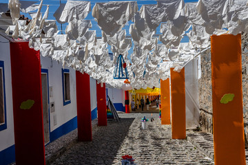 Street fully decorated with multicolored paper in Redondo village, Alentejo region, Portugal.