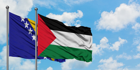 Bosnia Herzegovina and Palestine flag waving in the wind against white cloudy blue sky together. Diplomacy concept, international relations.