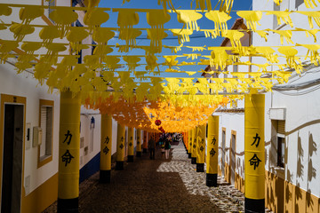 Street fully decorated with multicolored paper in Redondo village, Alentejo region, Portugal.