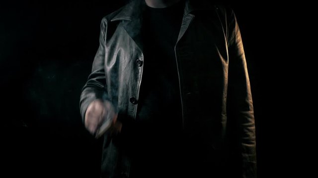 Man Smokes In Dramatic Darkness