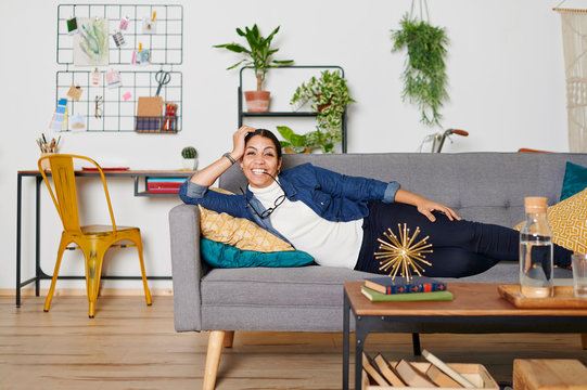 Young woman resting on a couch at living room