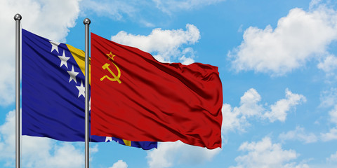 Bosnia Herzegovina and Soviet Union flag waving in the wind against white cloudy blue sky together. Diplomacy concept, international relations.