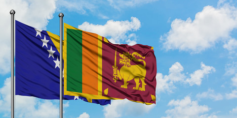 Bosnia Herzegovina and Sri Lanka flag waving in the wind against white cloudy blue sky together....