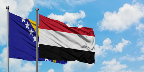 Bosnia Herzegovina and Yemen flag waving in the wind against white cloudy blue sky together....