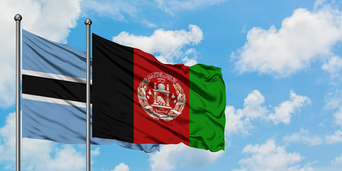 Botswana and Afghanistan flag waving in the wind against white cloudy blue sky together. Diplomacy concept, international relations.