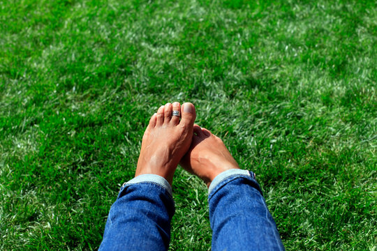 Bare Feet In Green Grass, Woman Relaxing In Nature