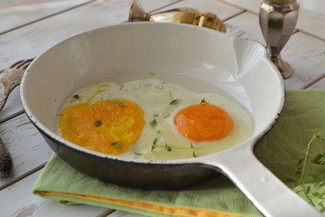 Healthy food concept: scrambled eggs in a little white pan on a shabby background