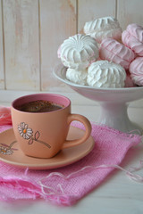 Homemade zephyr or marshmallow with pink cup of coffee on white shabby table. Valentine's or Mothers Day concept