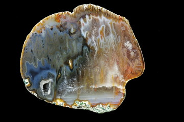 Stalactite agate, macro photography of the surface of the cut.  Multicolored silica bands colored...