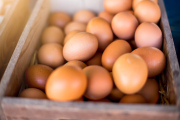 Many fresh eggs in wooden box. Product from the organic Farm.