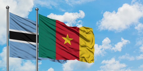 Botswana and Cameroon flag waving in the wind against white cloudy blue sky together. Diplomacy concept, international relations.
