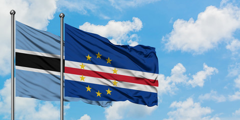 Botswana and Cape Verde flag waving in the wind against white cloudy blue sky together. Diplomacy concept, international relations.