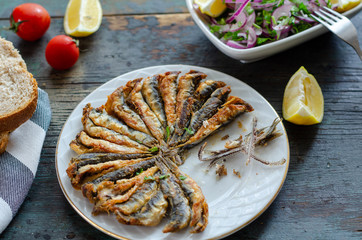 Fried anchovies fish and salad