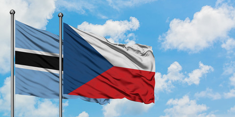 Botswana and Czech Republic flag waving in the wind against white cloudy blue sky together. Diplomacy concept, international relations.