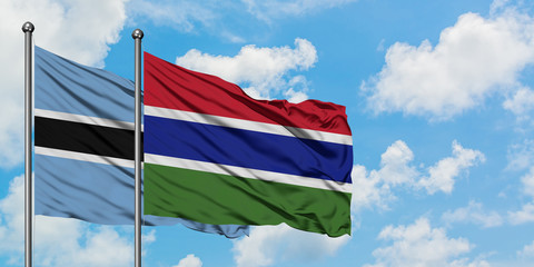 Botswana and Gambia flag waving in the wind against white cloudy blue sky together. Diplomacy concept, international relations.