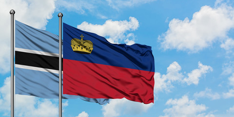 Botswana and Liechtenstein flag waving in the wind against white cloudy blue sky together. Diplomacy concept, international relations.