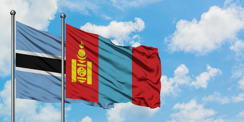 Botswana and Mongolia flag waving in the wind against white cloudy blue sky together. Diplomacy concept, international relations.