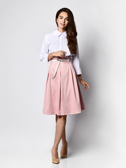 A successful young businesswoman, isolated on white background