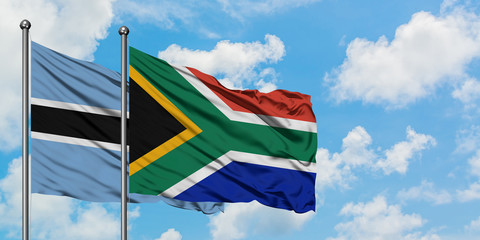 Botswana and South Africa flag waving in the wind against white cloudy blue sky together. Diplomacy concept, international relations.
