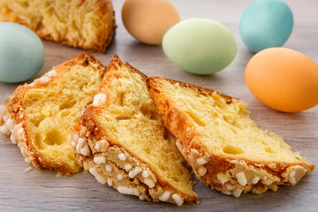 Slices of Easter cake and colorful eggs.