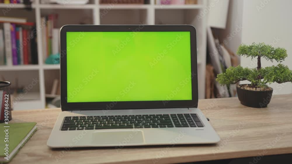 Wall mural close up laptop computer with green screen chroma key display internet business office technology wo