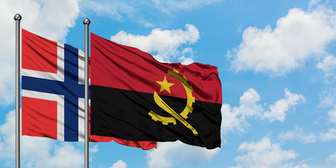 Bouvet Islands and Angola flag waving in the wind against white cloudy blue sky together. Diplomacy concept, international relations.