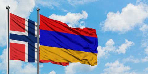 Bouvet Islands and Armenia flag waving in the wind against white cloudy blue sky together. Diplomacy concept, international relations.